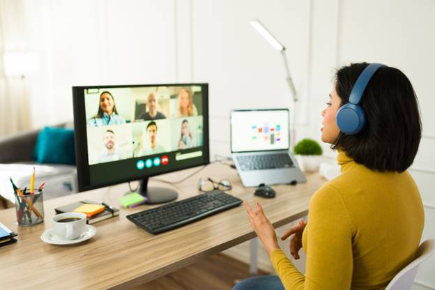 Woman talking on zoom with coworkers